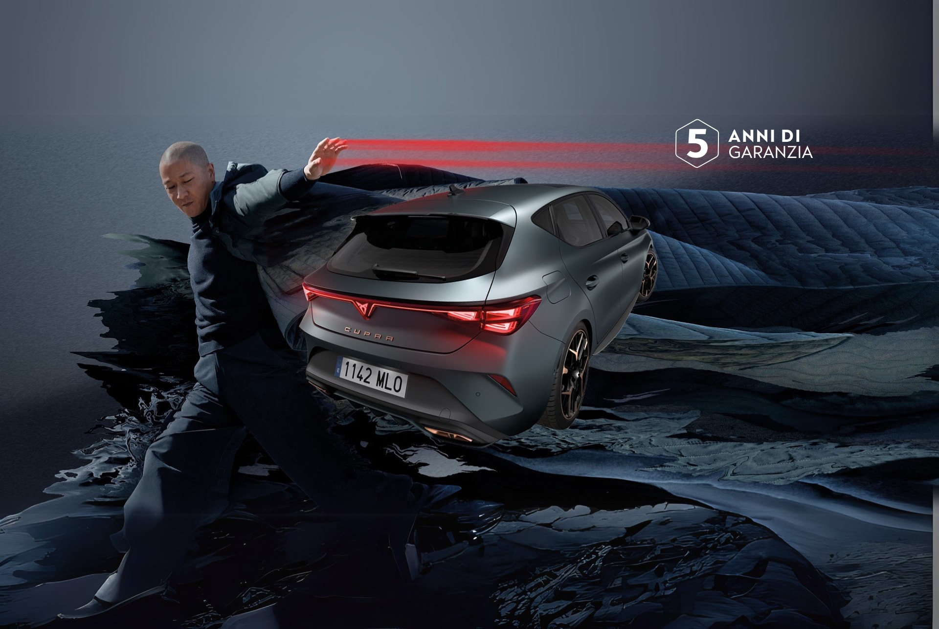 A new cupra leon 2024 in enceladus grey matte with copper accent alloy wheels parked on smooth concrete under an architectural structure. Barcelona cityscape in the background. 