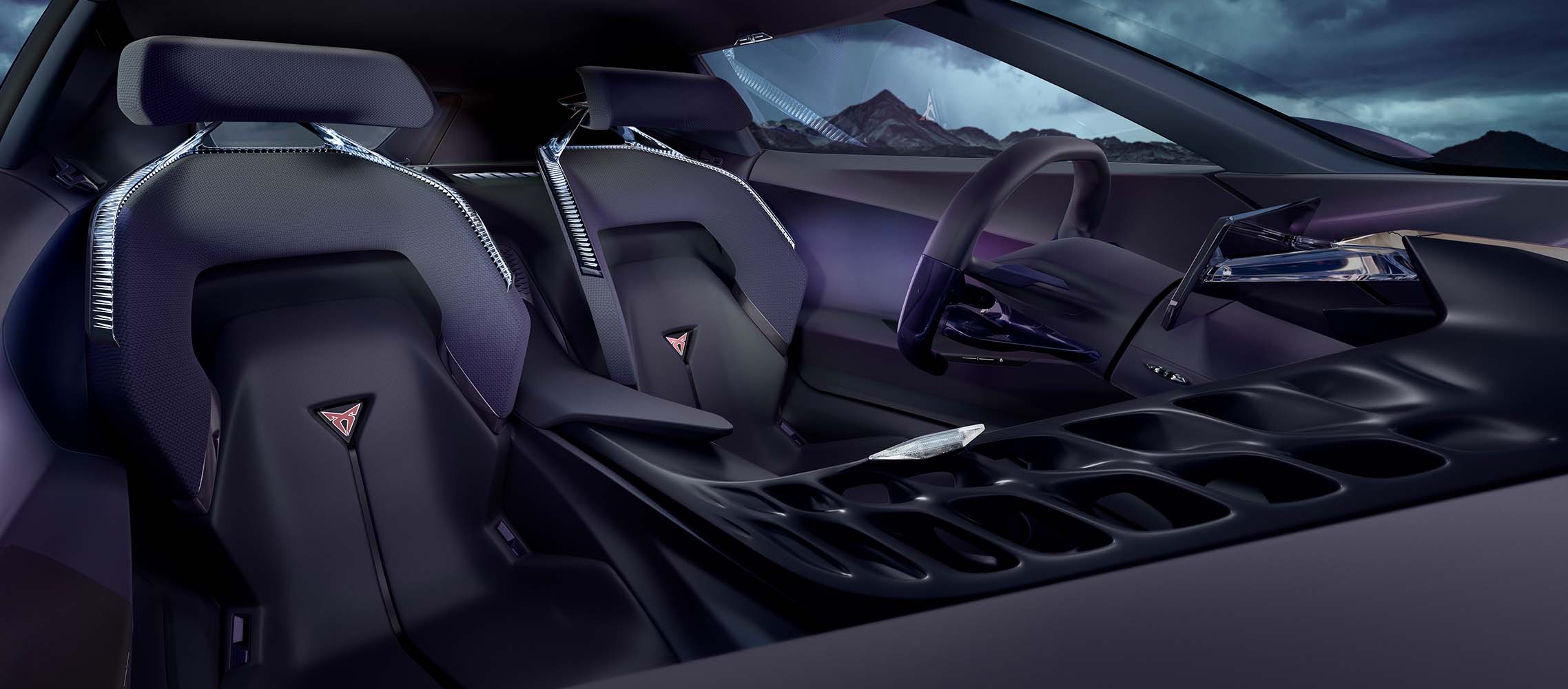 Die vorderen Schalensitze des CUPRA DarkRebel mit CUPRA Logos, zentralem Rückgrat, gamifiziertem Lenkrad und Infotainmentsystem.