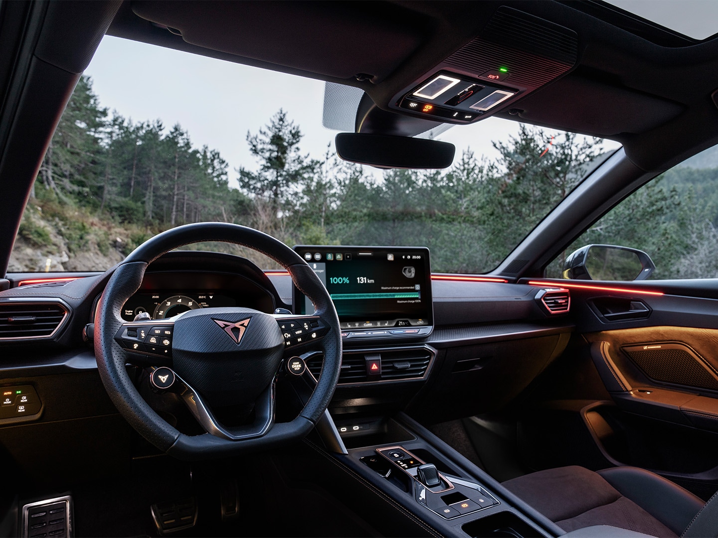 Interior view of the CUPRA Leon highlighting the driver-centric interface that includes a 12.9 touchscreen and a steering wheel with buttons and satellites.