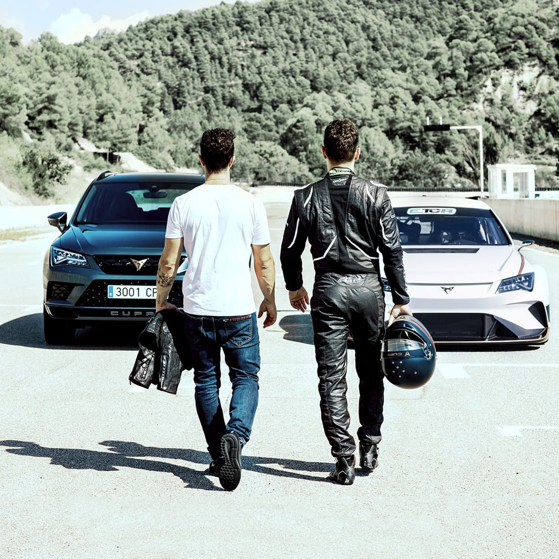 text: Andrea Dovizioso and Jorge Lorenzo in front of CUPRA Ateca and CUPRA e-Racer